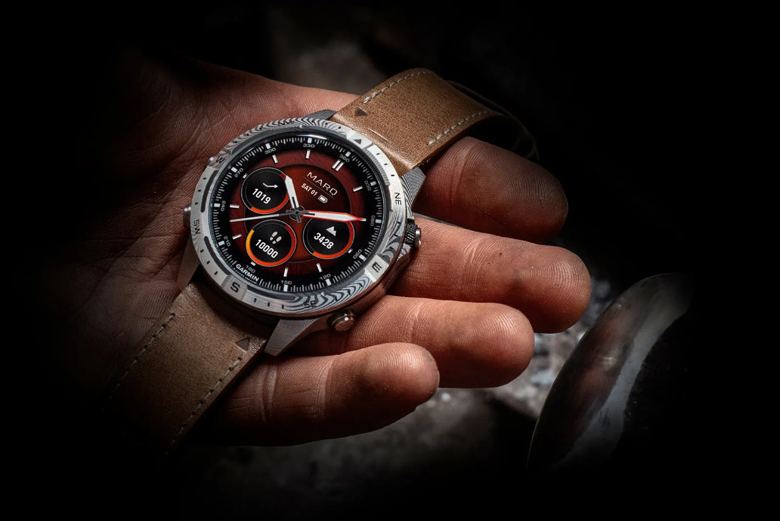 Garmin MARQ Gen 2 luxury smartwatch with red dial placed in the palm of a hand