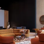 Salon aux canapés arrondis ocre et fauteuils terracotta, miroirs en soleil et mur sombre dans un showroom de design